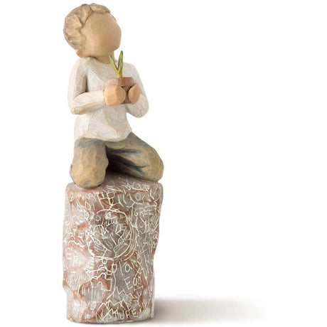 Boy on rock holding a pineapple ornament