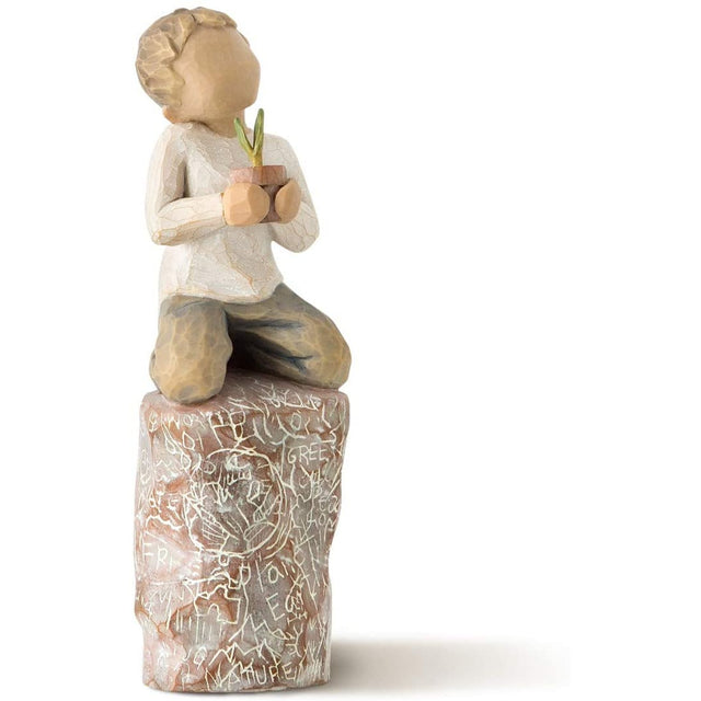 Boy on rock holding a pineapple ornament