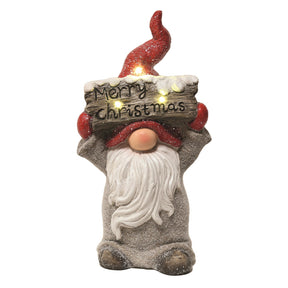 Large Gonk Statue holding a Merry Christmas sign above its head